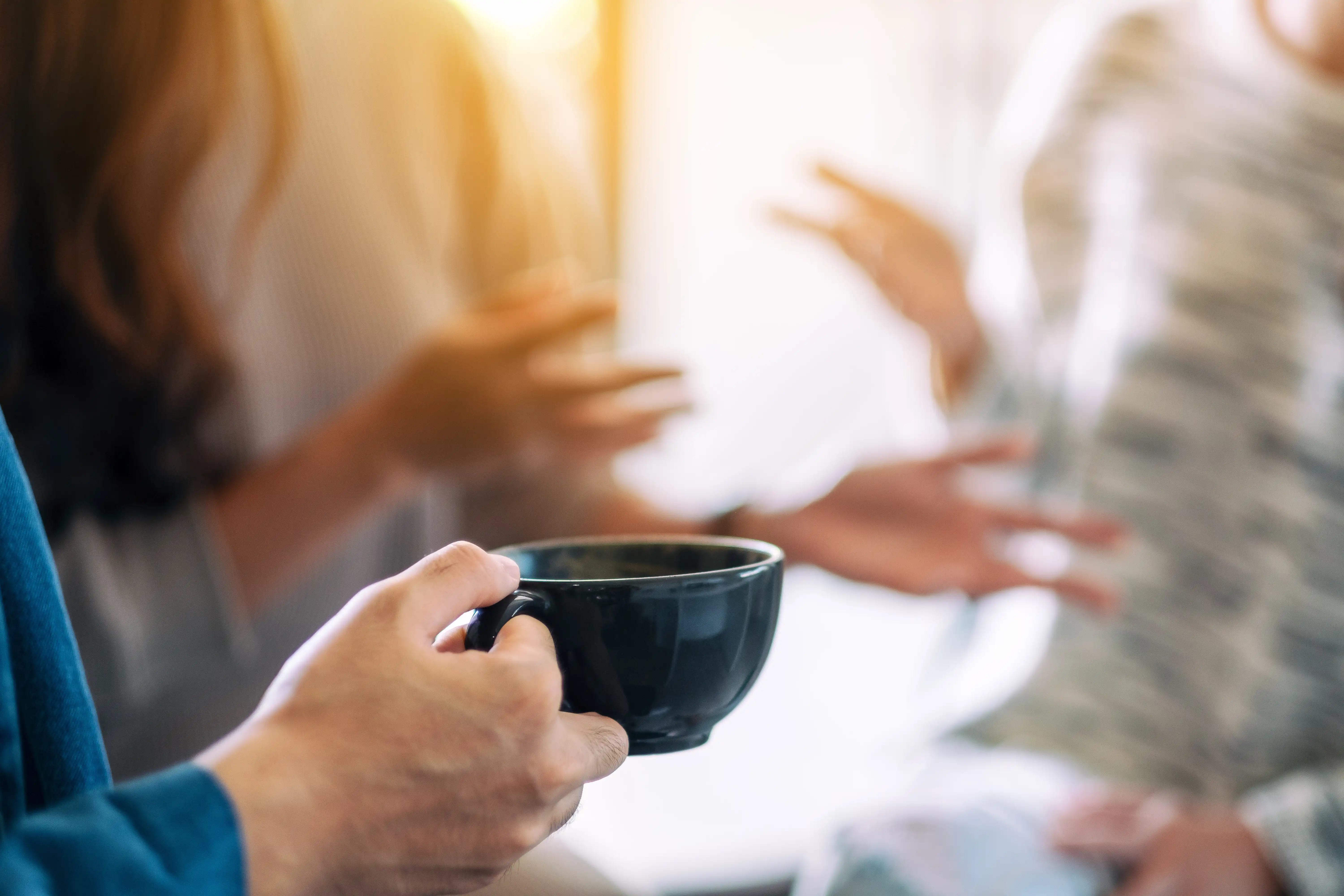 Two people in conversation over coffee